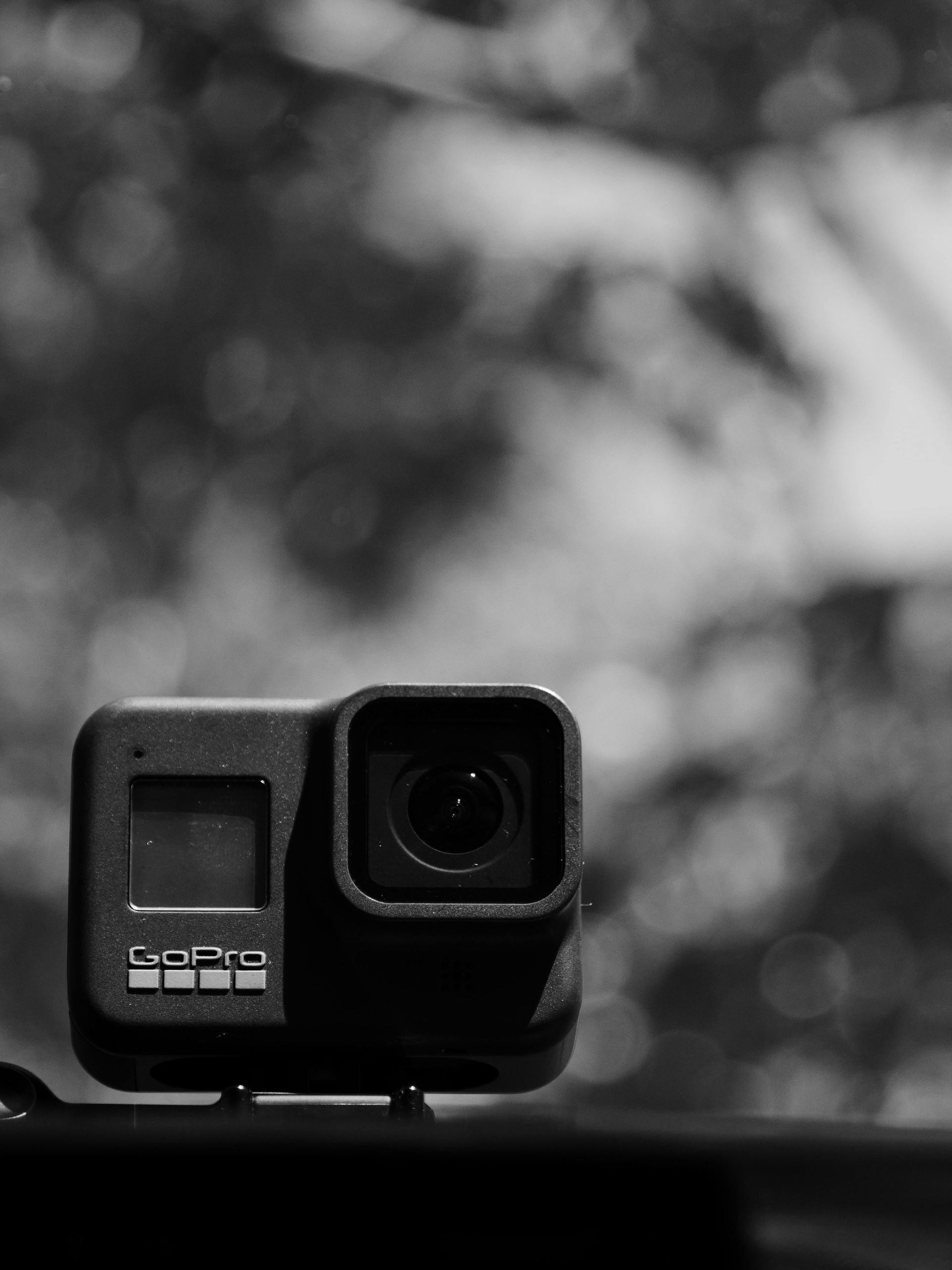 A black and white photo of a gopro camera.
